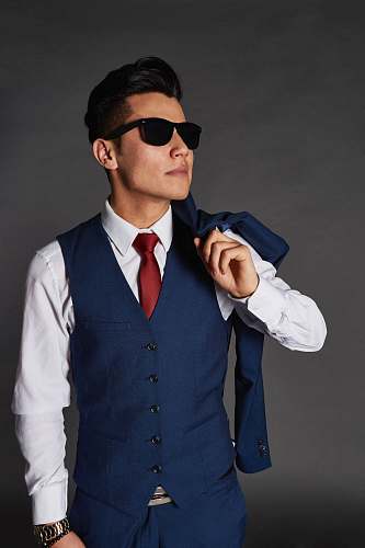 person man carrying blue jacket while looking sideways people