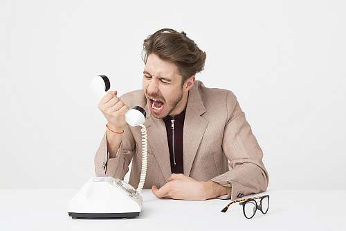 person man holding telephone screaming sitting