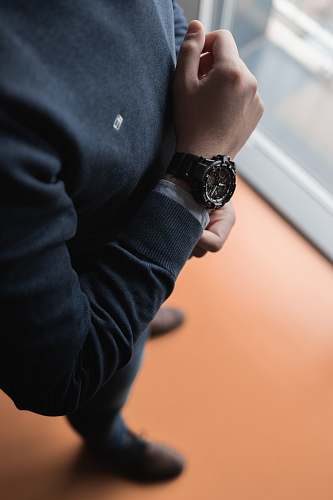 person man in black sweater wristwatch