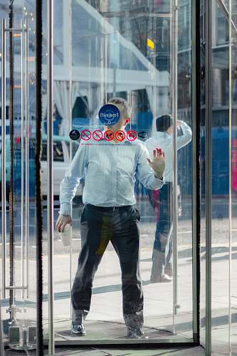 person man leaning on glass door people
