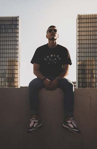 clothing man sitting on wall apparel