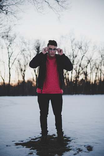 person man standing holding his eyeglasses people