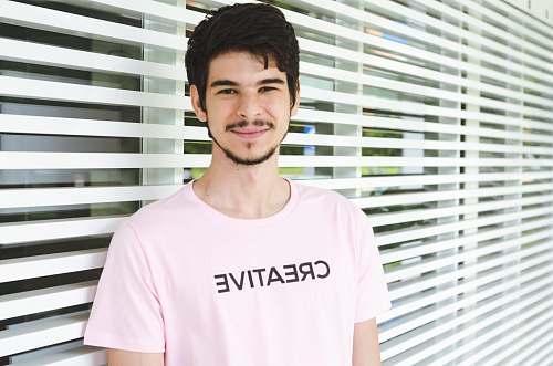 person man standing near window apparel