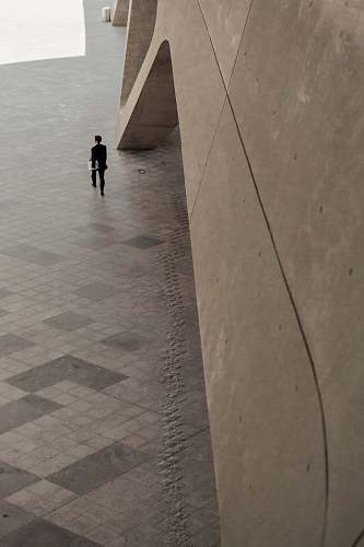 person man walking beside building floor