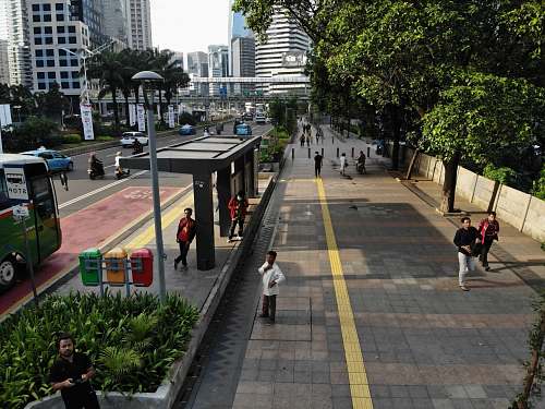 person people standing on waiting shed during daytime pedestrian
