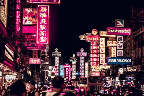 people people walking along road filled with LED signages person