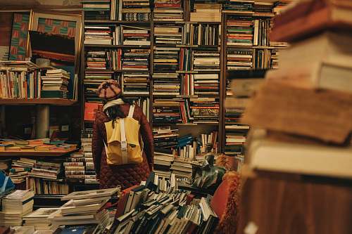 person person carrying backpack inside library book