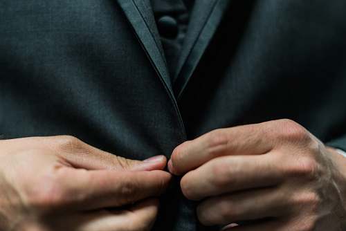 person person holding black suit jacket button suit