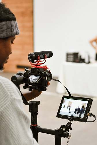 person person standing beside monitor camera