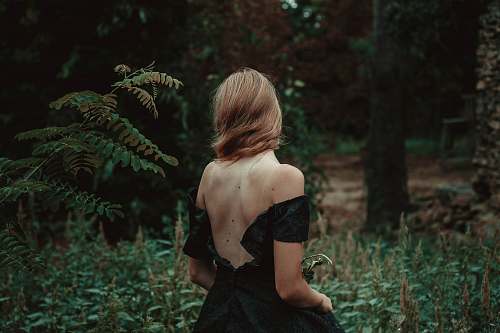 people selective focus photography of woman standing on forest person
