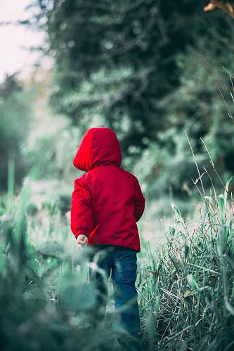 apparel toddler walking on grass field during daytime clothing