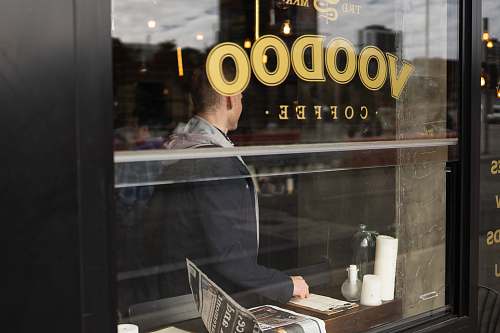 person Voodoo coffee sticker in glass cafe