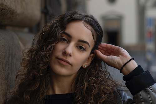 person woman fixing hair florence