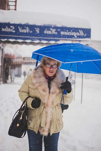 apparel woman holding blue umbrella clothing