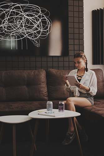 furniture woman sitting on tufted brown padded sofa couch