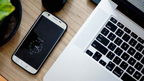 electronics smartphone beside MacBook Pro phone