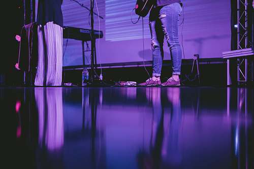 stage person playing guitar on stage band