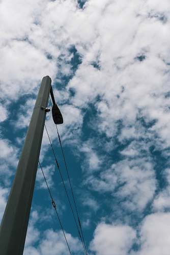sky grey concrete post under white clouds outdoors