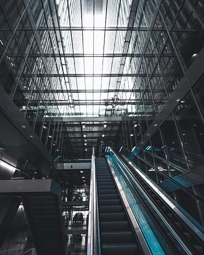 building black escalator inside glass building rotterdam