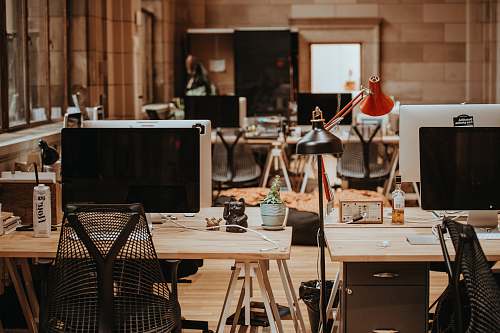 desk turned off flat screen monitors on top of beige desks restaurant