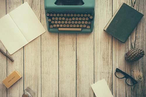 work vintage teal typewriter beside book desk