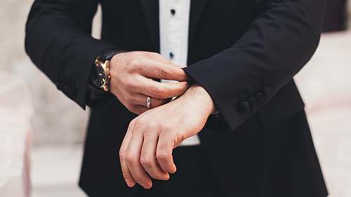 business A man's hands adjusting the cuffs of his black suit azerbaijan