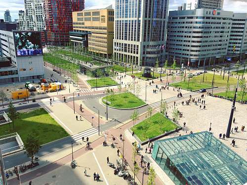 rotterdam aerial photography of people walking on park near city buildings aerial view