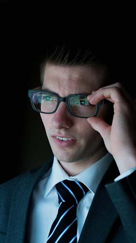 human man holding his eyeglasses person