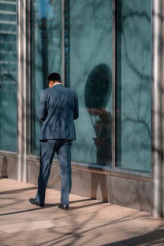 person man standing near glass wall human