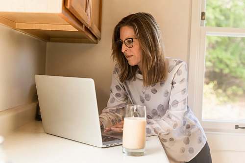 person woman using her MacBook Pro inside white room human