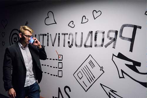 people man holding smartphone looking at productivity wall decor suit