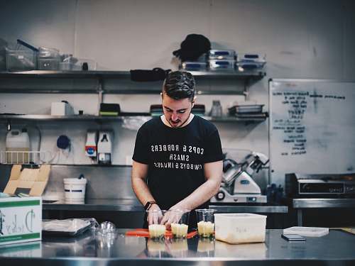 people man in black shirt beside kitchen table human