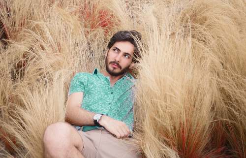 face man lying on brown grass human