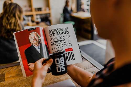 human man reading magazine book