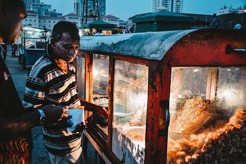 human man selling popcorn food