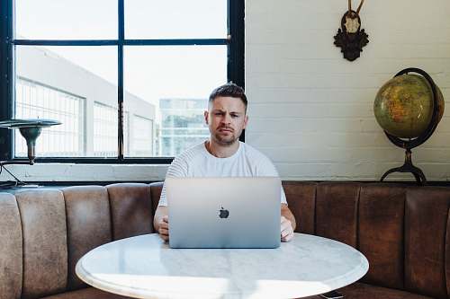 human man sitting infront of table furniture