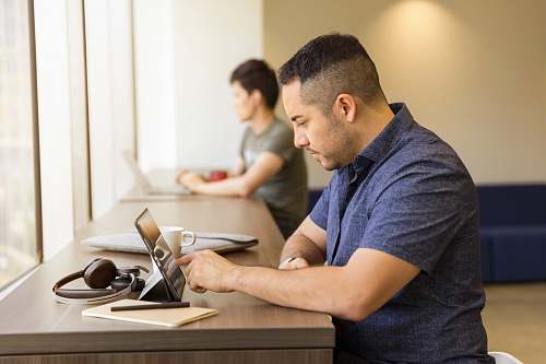 human man touching tablet computer on desk people