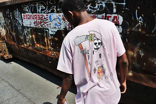 human man wearing pink crew-neck shirt graffiti