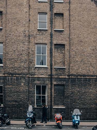 human motorcycles parked in front of bricked building at daytime home decor