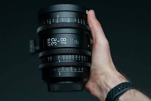human person holding 18-35 T2.0 camera zoom lens camera