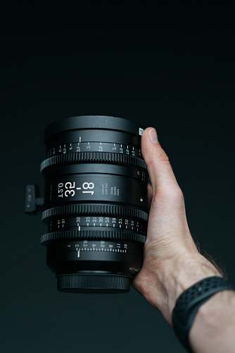 human person holding camera lens camera