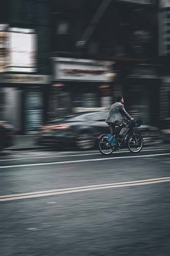human person riding bicycle on road machine