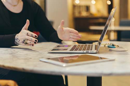 human person showing laptop computer on table pc
