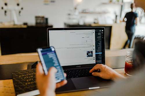 electronics person using phone and laptop pc