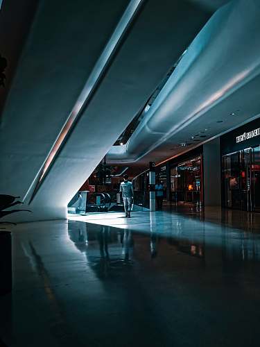 human person walking beside escalator housing