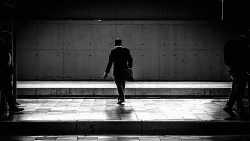 human person walking in the station black-and-white