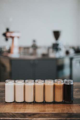 human selective focus photography of glass with liquid in it coffee