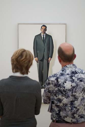 human two man standing in front of the painting people