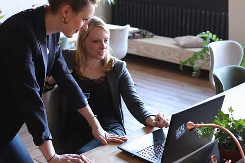 human two woman looking at laptop screen computer