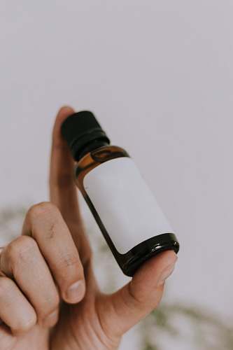 human white and brown glass bottle bottle